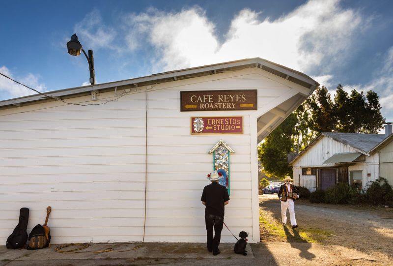 Día de los Muertos in Bolinas California. Masked man walking down the barn