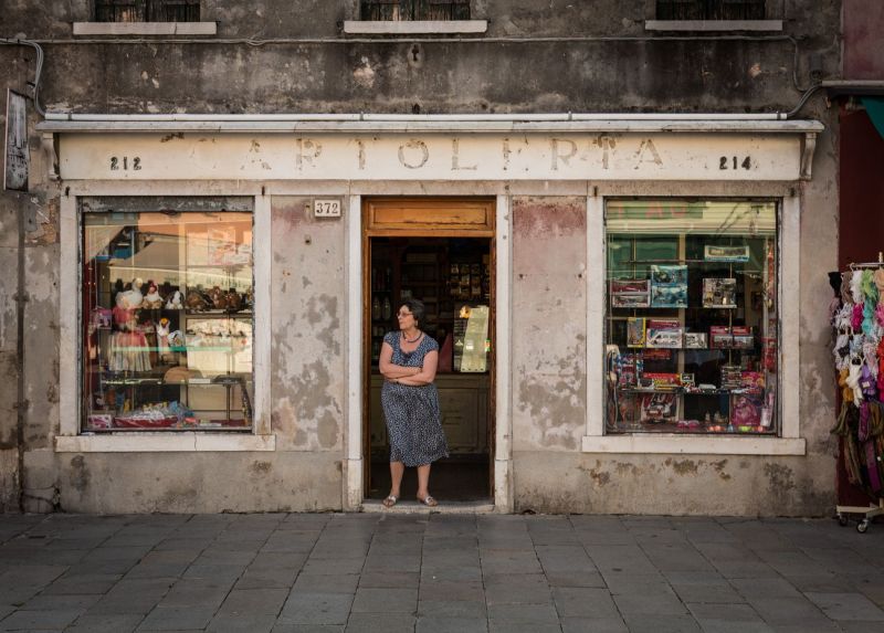 Stationary store with lady on the street of Venezia