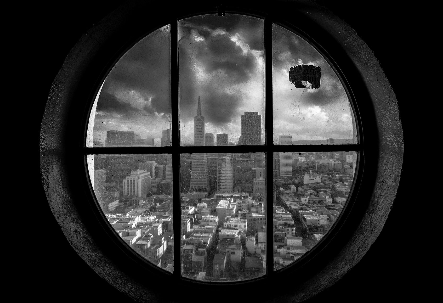 Black and white photo from the Coit Tower in San Francisco with the view of Downtown and dramatic sky