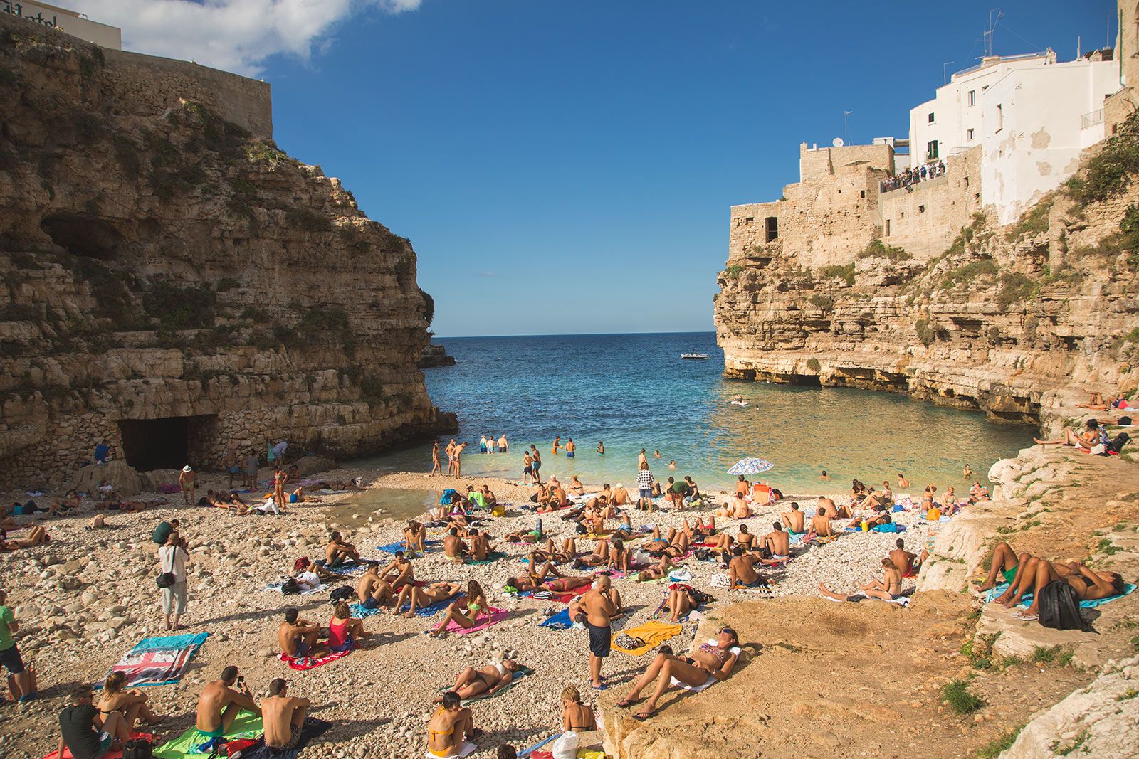 Polignano a Mare Beach during the summertime. Italian lifestyle at its best with turquoise water